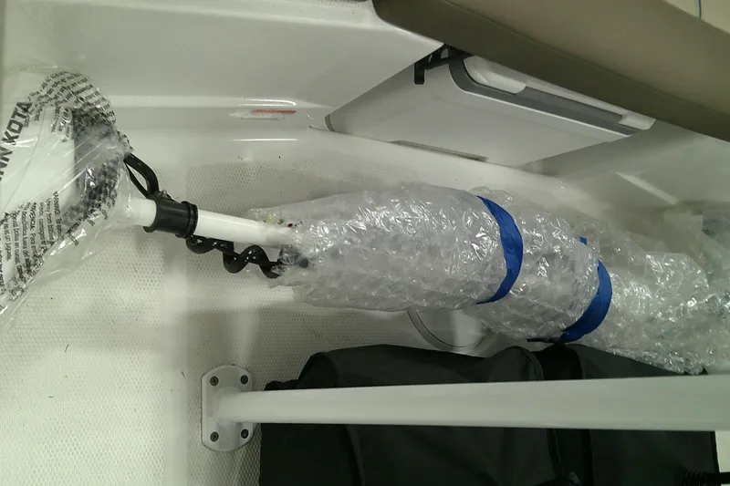 Slide: The Image of 2026 Tahoe 2150 CC boat interior with wrapped equipment and storage compartment. - 15