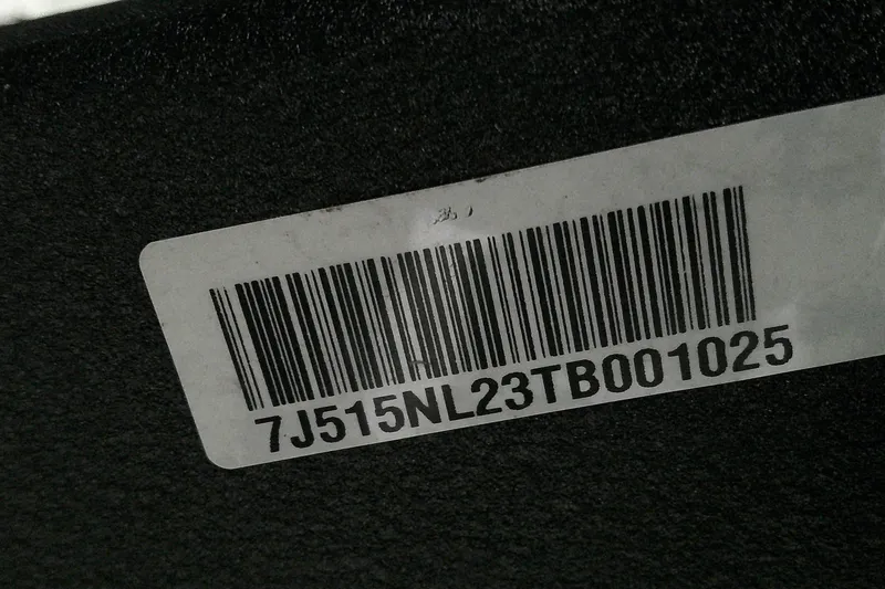 Slide: The Image of Barcode label on a 2026 Tahoe 2150 CC, displaying serial number 7J515NL23TB001025. - 17