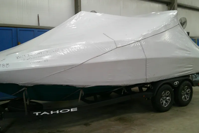Slide: The Image of Covered 2026 Tahoe 2150 CC boat on trailer in storage facility. - 9