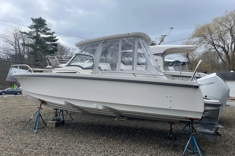 The Image of 2023 Nimbus Tender 8 boat on stands, displayed outdoors, with a "For Sale" sign. - 0