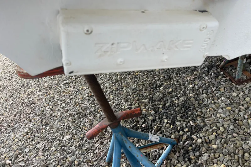 Slide: The Image of 2023 Nimbus Tender 8 with Zipwake system on gravel surface. - 11