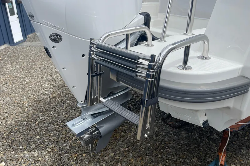 Slide: The Image of Stainless steel ladder on 2023 Nimbus Tender 8 boat, near outboard motor. - 12