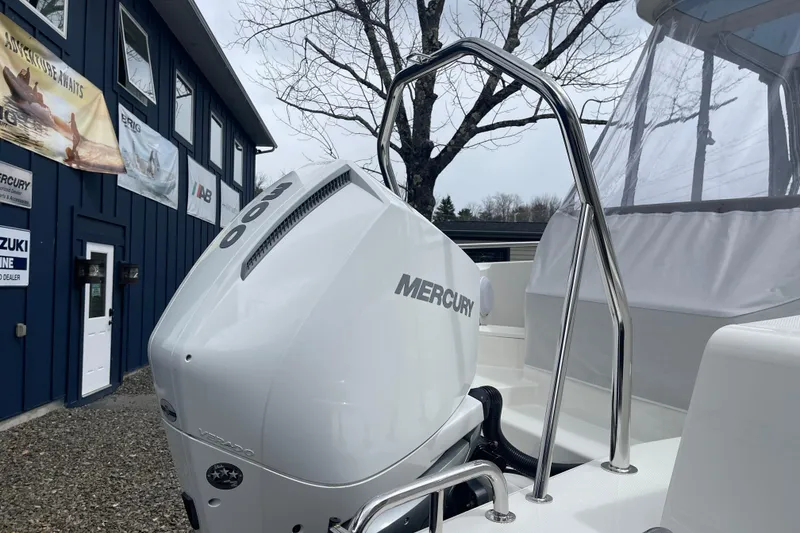 Slide: The Image of 2023 Nimbus Tender 8 with Mercury outboard engine, parked near a blue building. - 13
