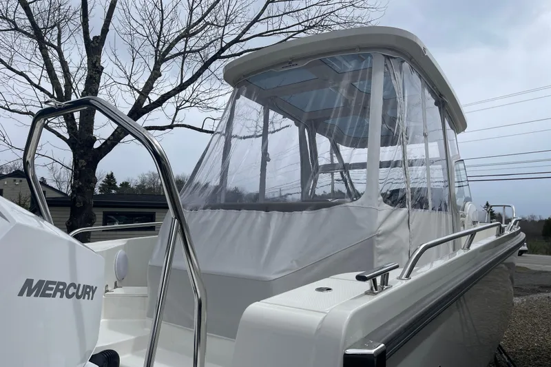 Slide: The Image of 2023 Nimbus Tender 8 boat with Mercury engine, featuring a clear canopy and sleek design. - 14