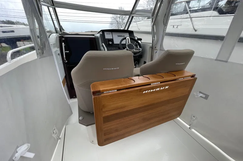 Slide: The Image of Interior of 2023 Nimbus Tender 8 boat with modern helm and wooden accents. - 17