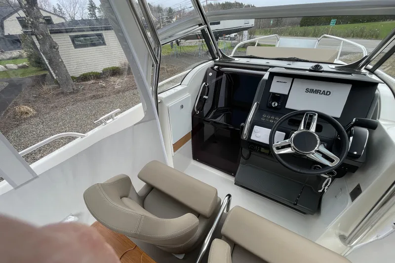 Slide: The Image of Interior view of 2023 Nimbus Tender 8 boat cockpit with steering wheel and navigation system. - 18