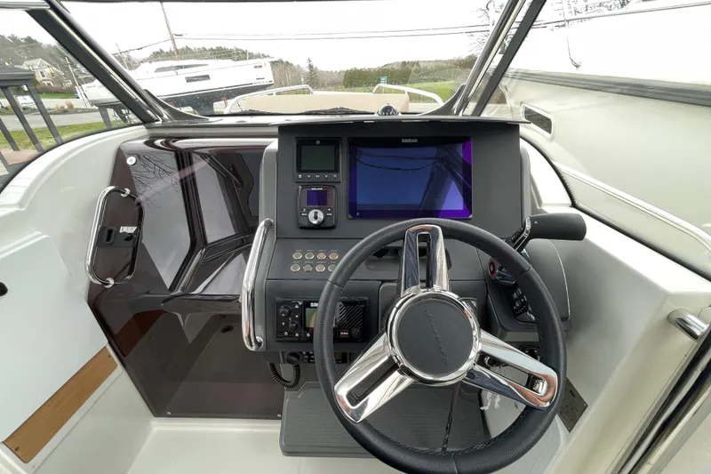 Slide: The Image of Cockpit of 2023 Nimbus Tender 8 with steering wheel and navigation display. - 21