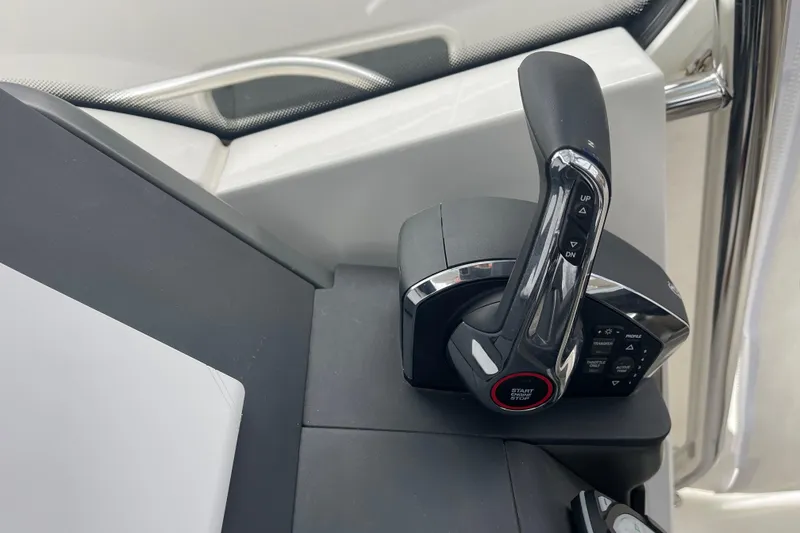 Slide: The Image of Control panel of 2023 Nimbus Tender 8 boat with throttle lever and buttons. - 22