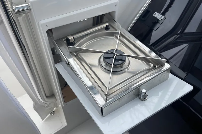 Slide: The Image of Stainless steel stove on 2023 Nimbus Tender 8 boat, featuring a compact design. - 27