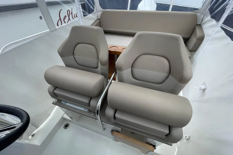 Slide: The Image of 2023 Nimbus Tender 8 boat interior with beige seating and steering wheel. - 28