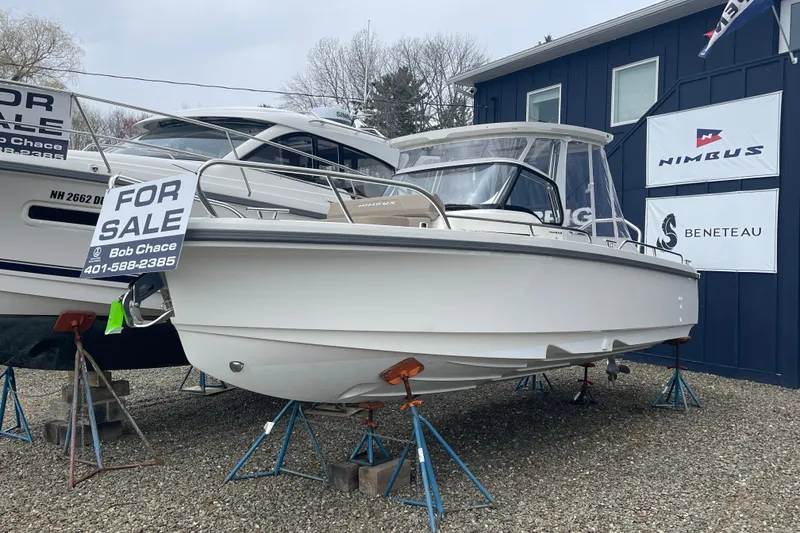 Slide: The Image of 2023 Nimbus Tender 8 boat for sale, displayed on stands with contact information. - 3