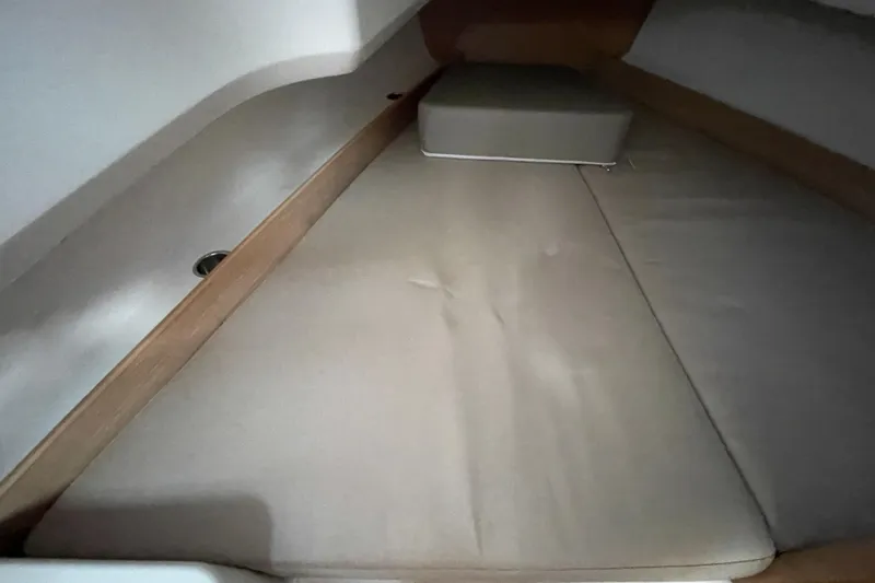 Slide: The Image of Interior cabin of 2023 Nimbus Tender 8, featuring beige cushions and wooden accents. - 32