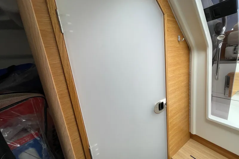 Slide: The Image of Interior cabin door of 2023 Nimbus Tender 8 boat, featuring sleek wood finish. - 37