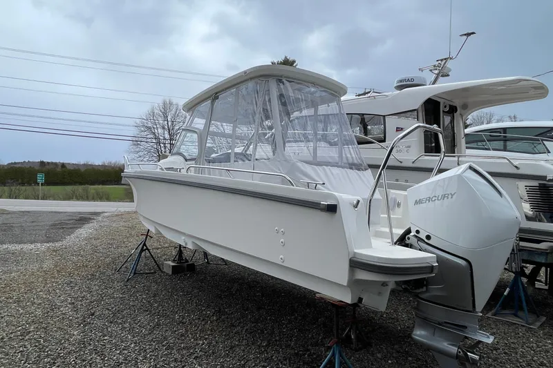 Slide: The Image of 2023 Nimbus Tender 8 boat with Mercury engine on display outdoors. - 7