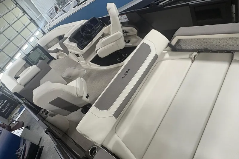 Slide: The Image of Interior of a 2026 Alera M25Q boat, featuring luxurious white seating and modern dashboard. - 18