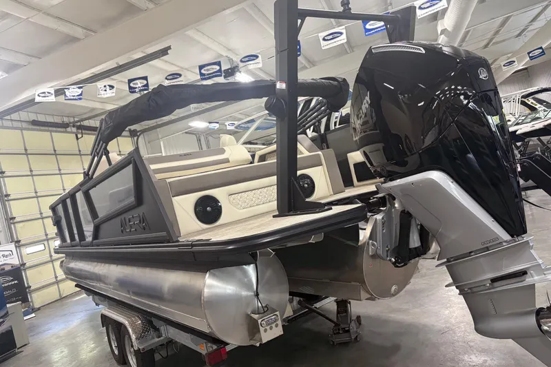 Slide: The Image of 2026 Alera M25Q pontoon boat with powerful outboard motor in showroom. - 19