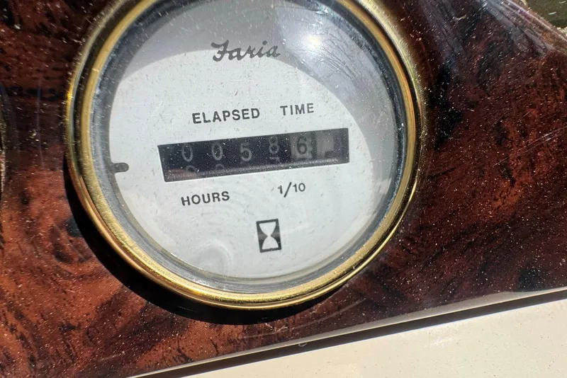 Slide: The Image of Close-up of Faria elapsed time gauge showing 58.6 hours on 2008 Voyager Pontoons boat. - 14