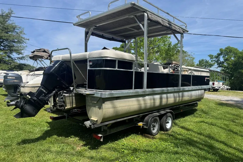 Slide: The Image of 2008 Voyager Pontoons 25 Extreme Cruise Express on trailer, parked on grass. - 2