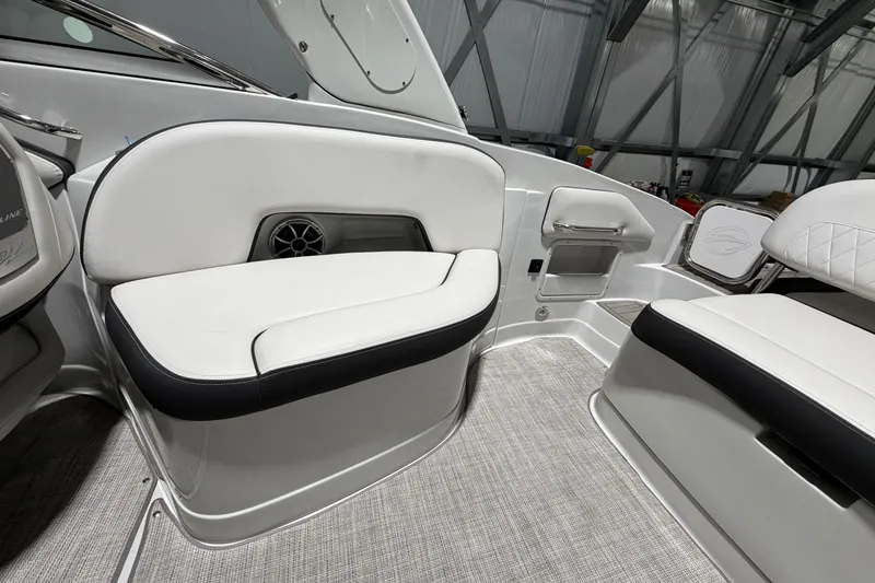 Slide: The Image of 2023 Crownline 280 SS boat interior with white seating and modern design. - 11