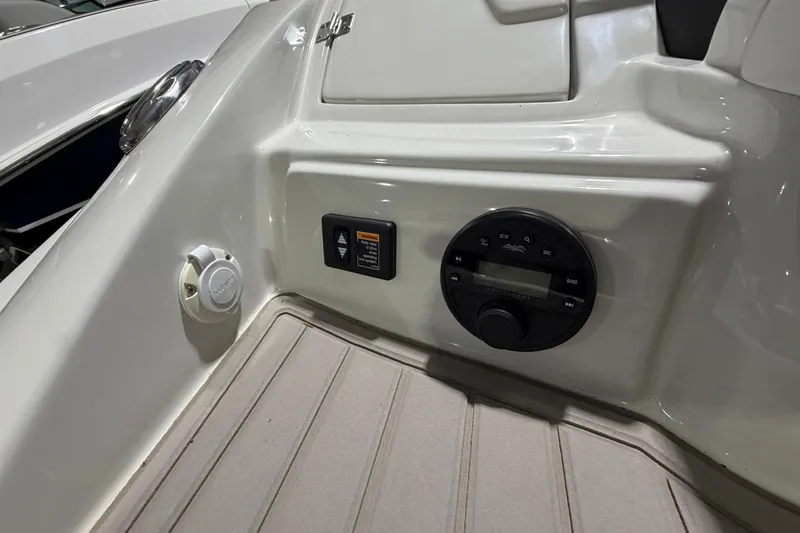 Slide: The Image of Control panel on 2023 Crownline 280 SS boat, featuring audio system and switches. - 17