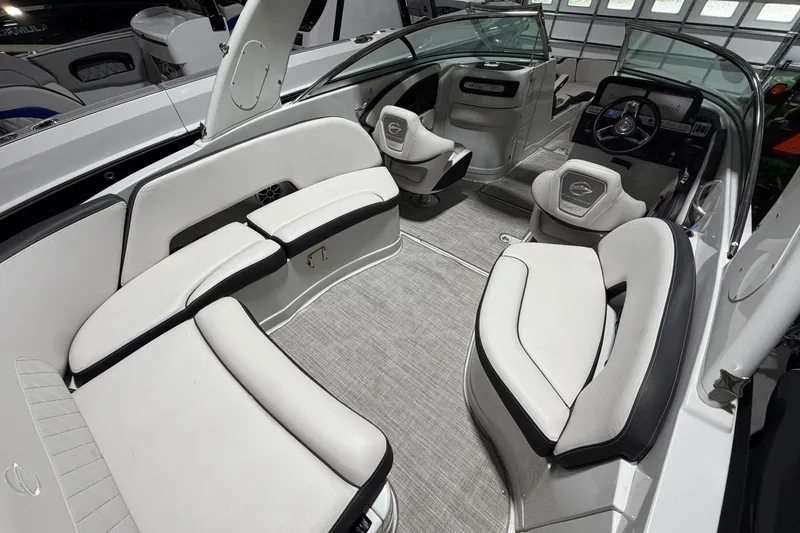 Slide: The Image of 2023 Crownline 280 SS boat interior with luxurious seating and modern dashboard. - 18