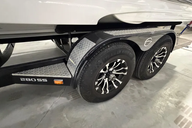 Slide: The Image of 2023 Crownline 280 SS boat trailer with dual wheels and diamond plate fenders. - 24