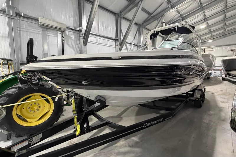 Slide: The Image of 2023 Crownline 280 SS boat in a storage facility, on a trailer. - 25