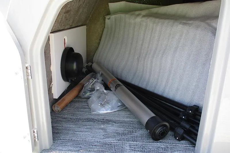 Slide: The Image of Storage compartment of 2026 Bentley Pontoons Fish 243 4-Point, featuring fishing gear and accessories. - 25