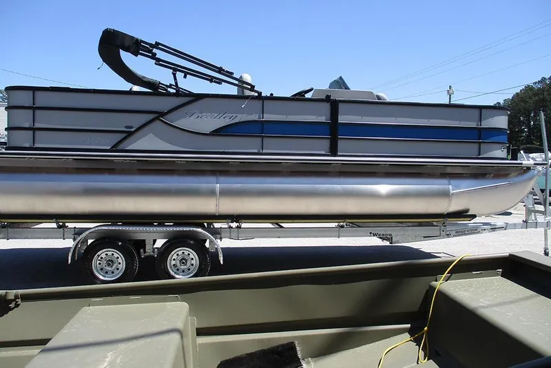 Slide: The Image of 2026 Bentley Pontoons Fish 243 4-Point on trailer, side view, outdoors. - 6