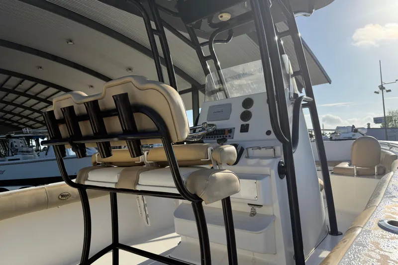 Slide: The Image of 2016 Key West 239 FS boat interior with helm and seating under a canopy. - 10