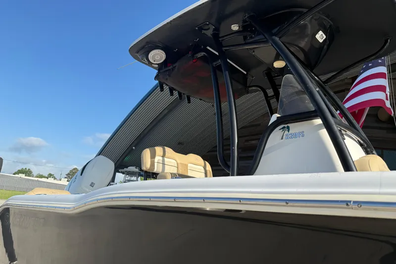 Slide: The Image of 2016 Key West 239 FS boat with American flag, under clear blue sky. - 17