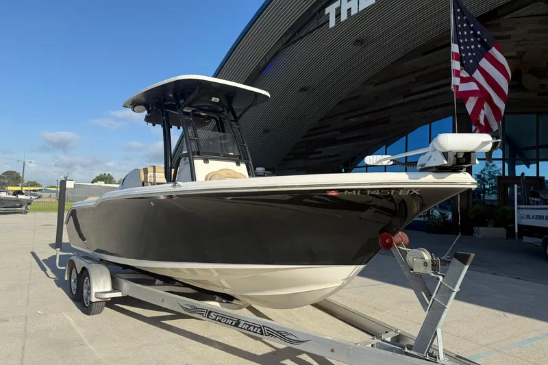 Slide: The Image of 2016 Key West 239 FS boat on trailer, American flag, sunny day. - 3