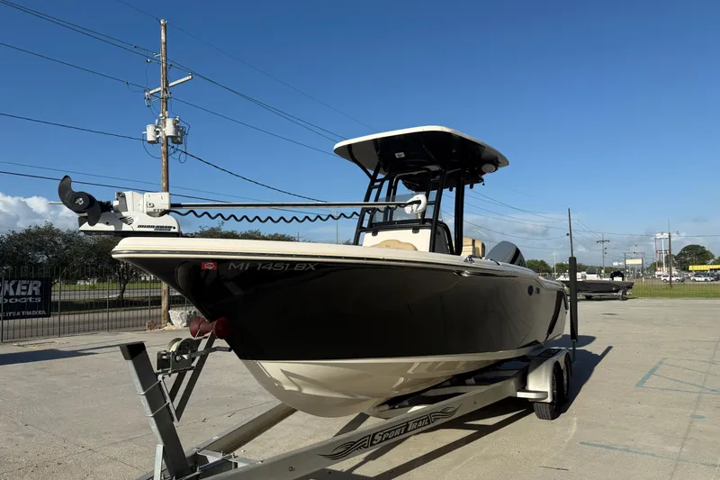 Slide: The Image of 2016 Key West 239 FS boat on trailer under clear blue sky. - 4