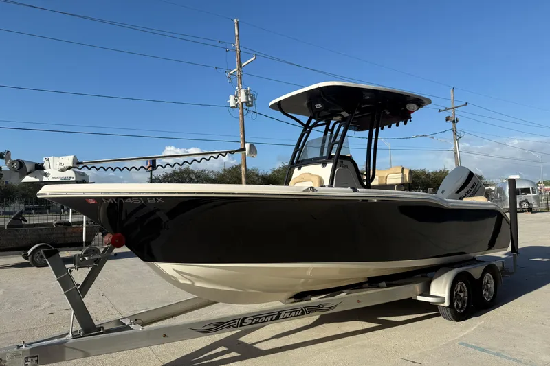 Slide: The Image of 2016 Key West 239 FS boat on trailer, black hull, clear sky background. - 5