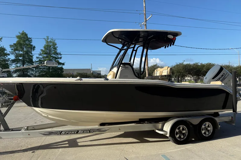 Slide: The Image of 2016 Key West 239 FS boat on trailer, black hull, sunny day. - 6