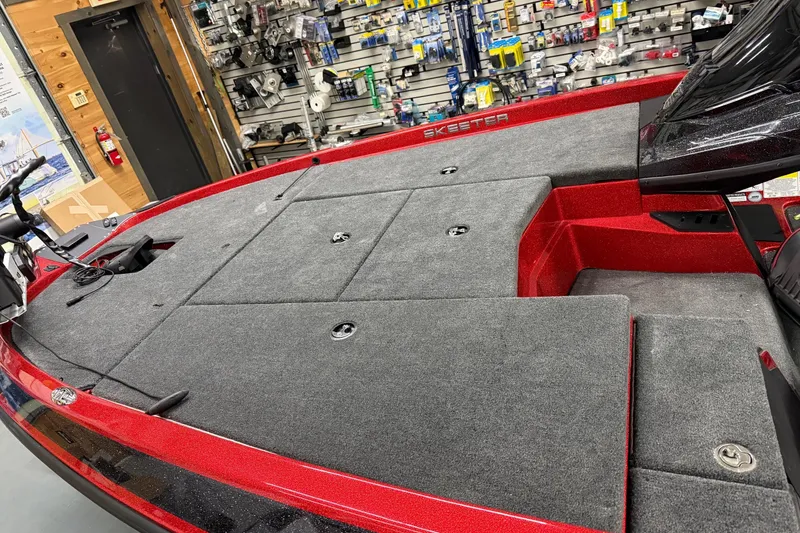 Slide: The Image of 2026 Skeeter ZX150 boat deck in a showroom, featuring red and gray design. - 12
