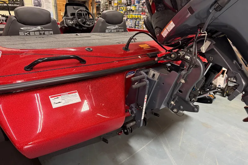 Slide: The Image of 2026 Skeeter ZX150 boat interior with red finish and motor details. - 14