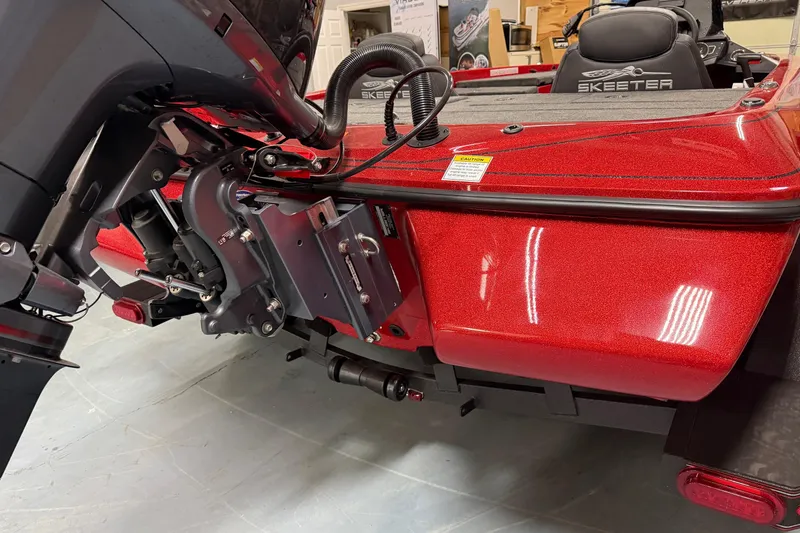 Slide: The Image of 2026 Skeeter ZX150 boat, red exterior, detailed view of motor and rear deck. - 15