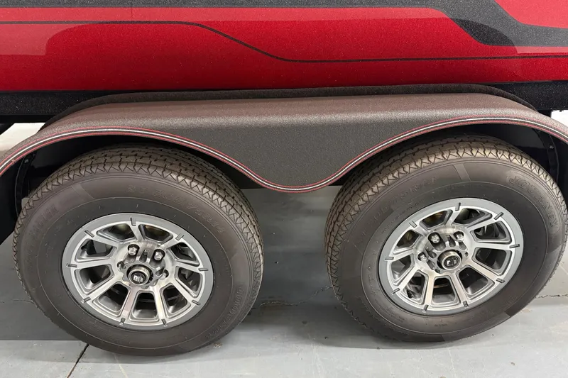 Slide: The Image of Dual wheels on a 2026 Skeeter ZX150 trailer with red and black detailing. - 18