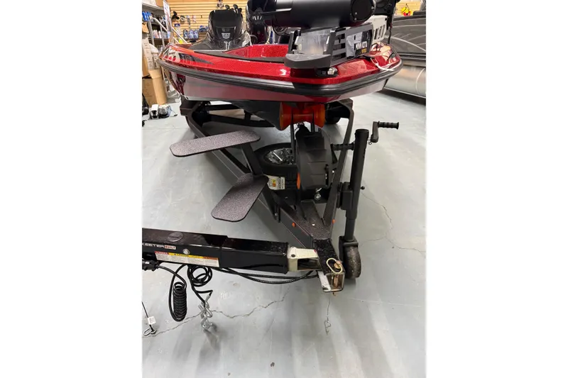 Slide: The Image of 2026 Skeeter ZX150 boat on trailer, featuring red hull and advanced equipment. - 7