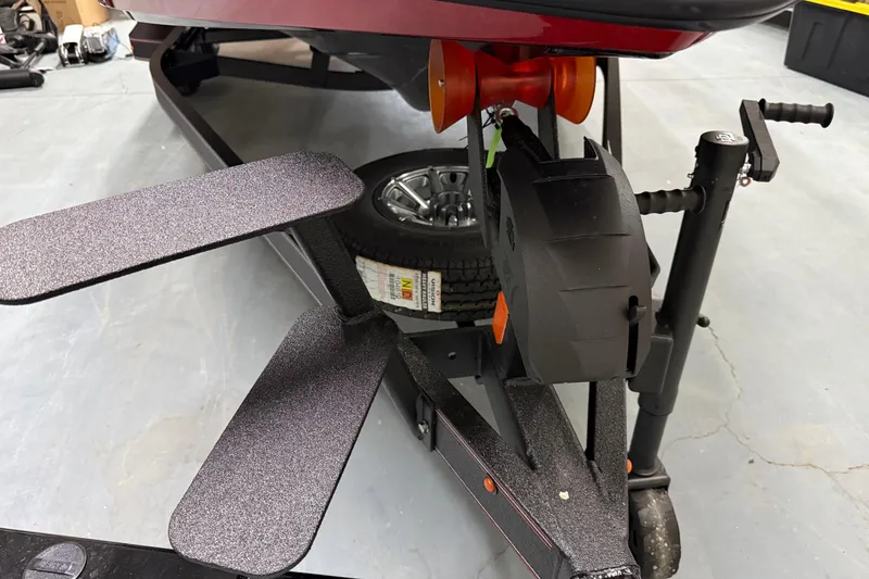 Slide: The Image of 2026 Skeeter ZX150 boat trailer with winch and step pads in a garage. - 8