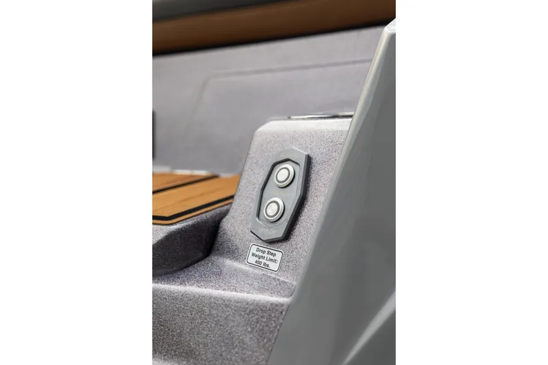 Slide: The Image of Close-up of 2025 Supra SE 550 boat controls and step weight limit label. - 10