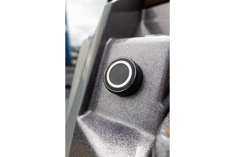 Slide: The Image of Close-up of a control knob on a 2025 Supra SE 550 boat dashboard. - 13