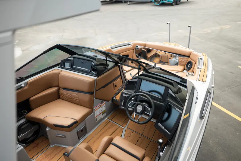 Slide: The Image of Luxurious interior of 2025 Supra SE 550 boat with tan leather seating and modern dashboard. - 16