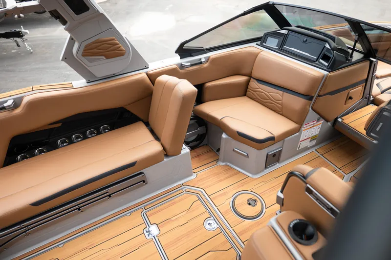 Slide: The Image of Luxurious interior of 2025 Supra SE 550 boat with tan leather seating and sleek design. - 18