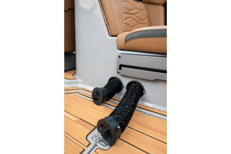 Slide: The Image of 2025 Supra SE 550 interior with tan leather seats and black coiled footrests. - 21