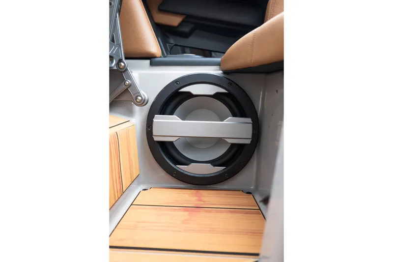 Slide: The Image of 2025 Supra SE 550 interior speaker with wooden flooring and modern design elements. - 23