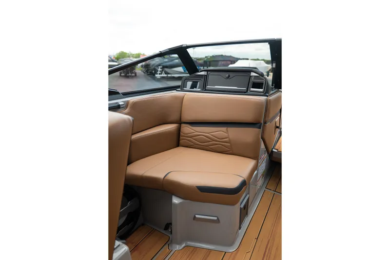 Slide: The Image of Luxurious interior seating of 2025 Supra SE 550 boat with tan upholstery. - 24