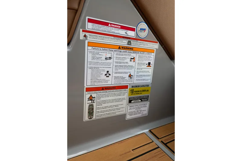 Slide: The Image of Warning labels on 2025 Supra SE 550 boat, detailing safety instructions and capacity limits. - 28