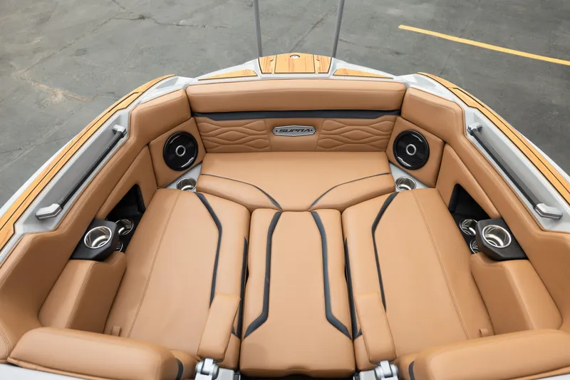 Slide: The Image of Luxurious tan leather seating in 2025 Supra SE 550 boat interior with speakers and cup holders. - 29